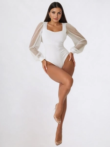 Elegant white bodysuit with mesh lantern sleeves and sweetheart neckline on model