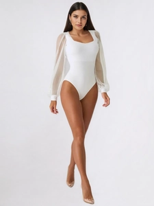 Detail of white bodysuit showing elegant chiffon lantern sleeves and cuff buttons