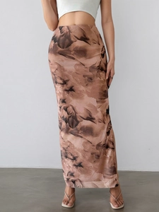 Detail view of the brown abstract print pattern on a high-waisted chic long skirt