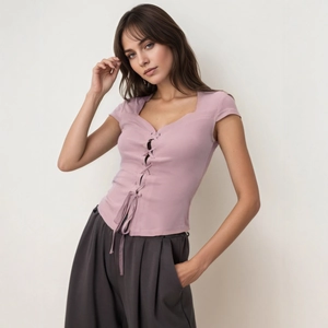 Detail of light purple slim fit top with front lace-up V-neck and short sleeves