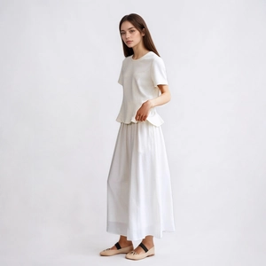 Detailed view of the ruffle hem on a white slim-fit short sleeve T-shirt with a round neck