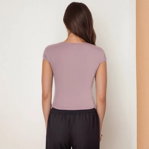 Detailed back view of a slim-fit dusty mauve short sleeve T-shirt with bandage design