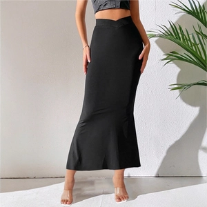 Detail of high waist black fishtail skirt with unique criss-cross V-shape waist design