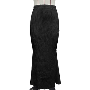 Detail of black high-waisted midi skirt with vertical wave pleats and elastic waist texture