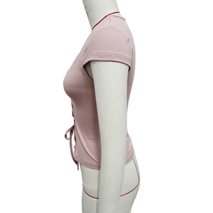 Detail view of pink slim fit crop top featuring side drawstring lace-up design