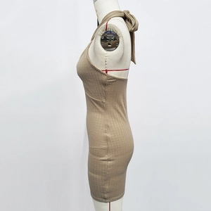 Detail of khaki knit mini dress showing halter neck tie and ribbed fabric texture