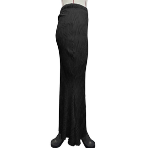 Close-up of black pleated long skirt showing elastic waist and vertical ripple texture