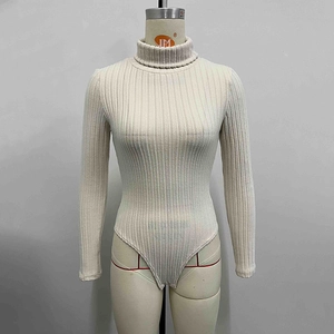 Detail of the high turtleneck and ribbed knit texture on the off-white long sleeve bodysuit