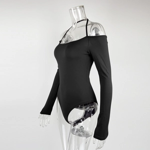 Detail showing the off-shoulder neckline and halter strap of a black long sleeve bodysuit
