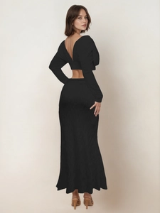 Detail of elegant black backless crop top and pleated maxi skirt in a two-piece set