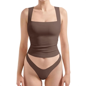 Detail of a brown double-layered stretch crop top with a square neck and matching bottom