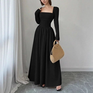 Detail view of the square neckline and slimming waist design on this elegant black dress