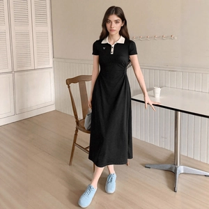 Detail of the chic contrast polo collar and bow accent on the slim black midi dress