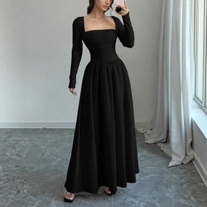 Detail of elegant black long sleeve maxi dress featuring square neckline and slim waist fit