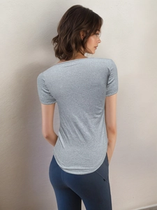 Women's slim fit grey short sleeve sports t-shirt and blue leggings for yoga and fitness