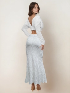 Chic two-piece set featuring a white crop top and pleated blue fishtail maxi skirt