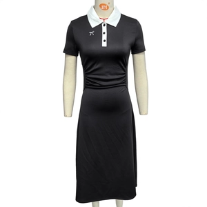 Detail of a black polo dress featuring a contrast white collar and a delicate bow print