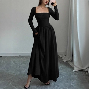 Detailed view of the vintage square neckline and high-waist slimming cut on a black dress