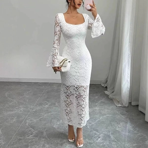 Close-up of intricate lace textures and elegant flared sleeve details on a white maxi dress