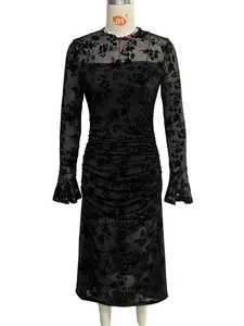 Detail of burnout mesh dress featuring flared cuffs and delicate floral flocking texture