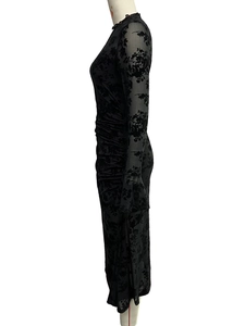 Close-up of black mesh dress featuring elegant flocked floral patterns and side ruching