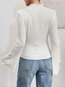 Slim fit white ribbed knit top with dramatic flare sleeves and ruffled collar back view