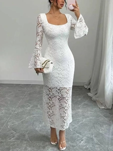 Elegant white lace dress with square neck and flared sleeves on a model in a minimalist room