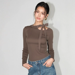 Detail of rib-knit brown top featuring asymmetrical neckline and bow tie decoration