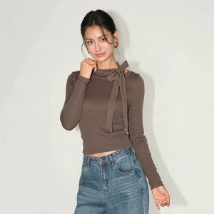 Close-up of brown ribbed knit sweater featuring a stylish bow-tie neck design