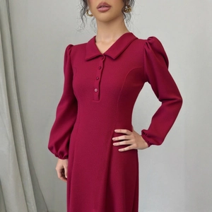 Détail de la robe en maille bordeaux avec col polo et manches bouffantes à boutons