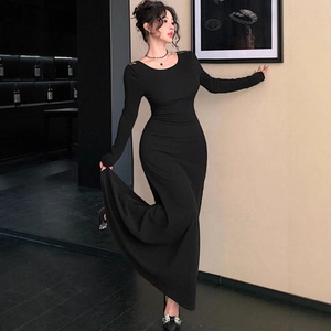 Close-up of a slim-fit black long-sleeve dress featuring a backless lace-up detail