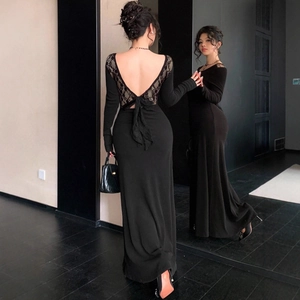 Detail of sexy backless black dress featuring floral lace trim and bow tie decoration