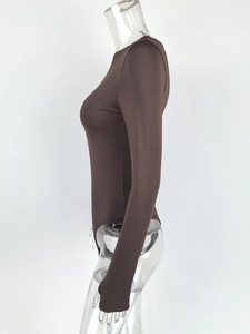 Close-up of the form-fitting dark brown bodysuit showing elastic knit fabric and sleeve seams
