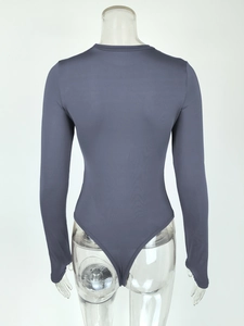 Detail view of the back of a dark grey long-sleeve bodysuit with high-stretch slim fit fabric