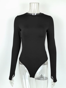 Detail of black long-sleeve bodysuit featuring thumbhole cuffs on a clear mannequin
