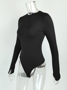 Detail of black bodysuit featuring functional thumbhole cuffs and stretchy fabric