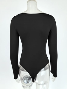 Rear view of black off-the-shoulder long sleeve bodysuit with slim fit and glossy fabric