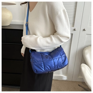Détail du sac bandoulière en nylon matelassé bleu vif avec sangle réglable et coutures quadrillées