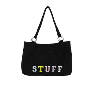 Black corduroy tote bag with colorful STUFF embroidery and metal ring straps