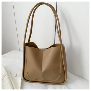 Detail of khaki faux leather tote bag with minimalist vertical stitching and long strap