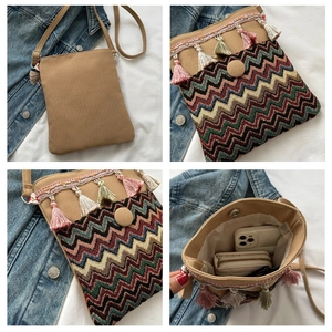 Detail of ethnic crossbody bag with tassel fringe and woven wave pattern on canvas