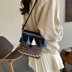 Ethnic bohemian crossbody bag with colorful tassels and geometric weave patterns