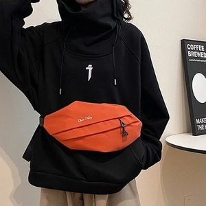 Orange canvas chest bag with unique pleated design and white embroidery on shoulder