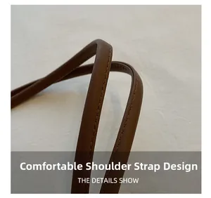 Close-up of comfortable brown leather shoulder strap with fine stitching details