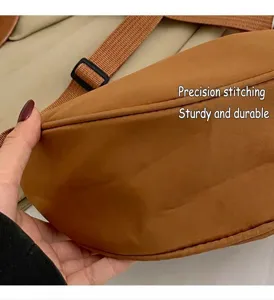 Detailed macro view showing the precise stitching and durable seams of the brown crossbody bag