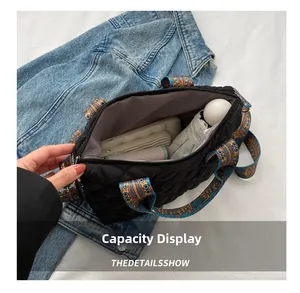 Capacity display of quilted tote bag with colorful ethnic strap showing daily items inside