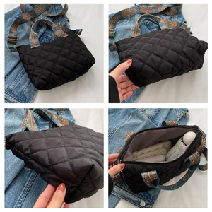 Quilted black nylon tote bag featuring a colorful ethnic print strap and spacious interior