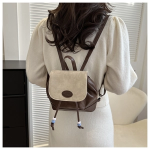Detail view of retro mini backpack with drawstring closure and blue accent beads