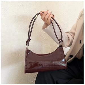 Chic burgundy faux crocodile leather handbag with knotted straps and gold hardware