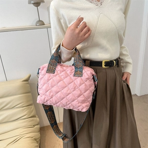 Pink quilted nylon tote bag with patterned handles and adjustable crossbody strap